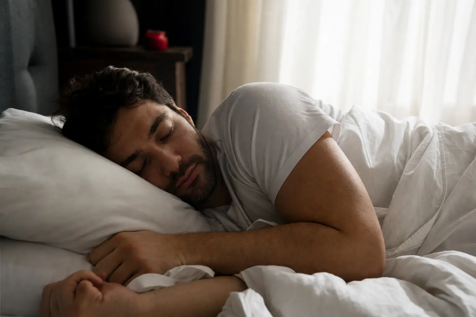 A person sleeping peacefully in morning light.